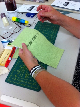 Book Arts Guild of Vermont member sewing a journal