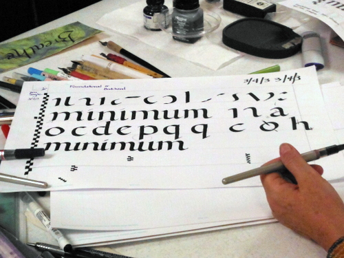 Penne Tompkins demonstrating calligraphy