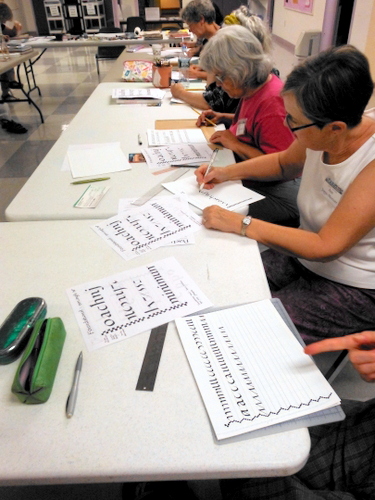 Book Arts Guild of Vermont members practicing calligraphy