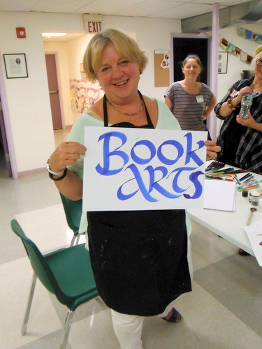 Penne Tompkins with Book Arts sign