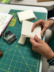 Book Arts Guild of Vermont member sewing a book