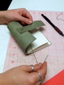 Book Arts Guild of Vermont member sewing a journal